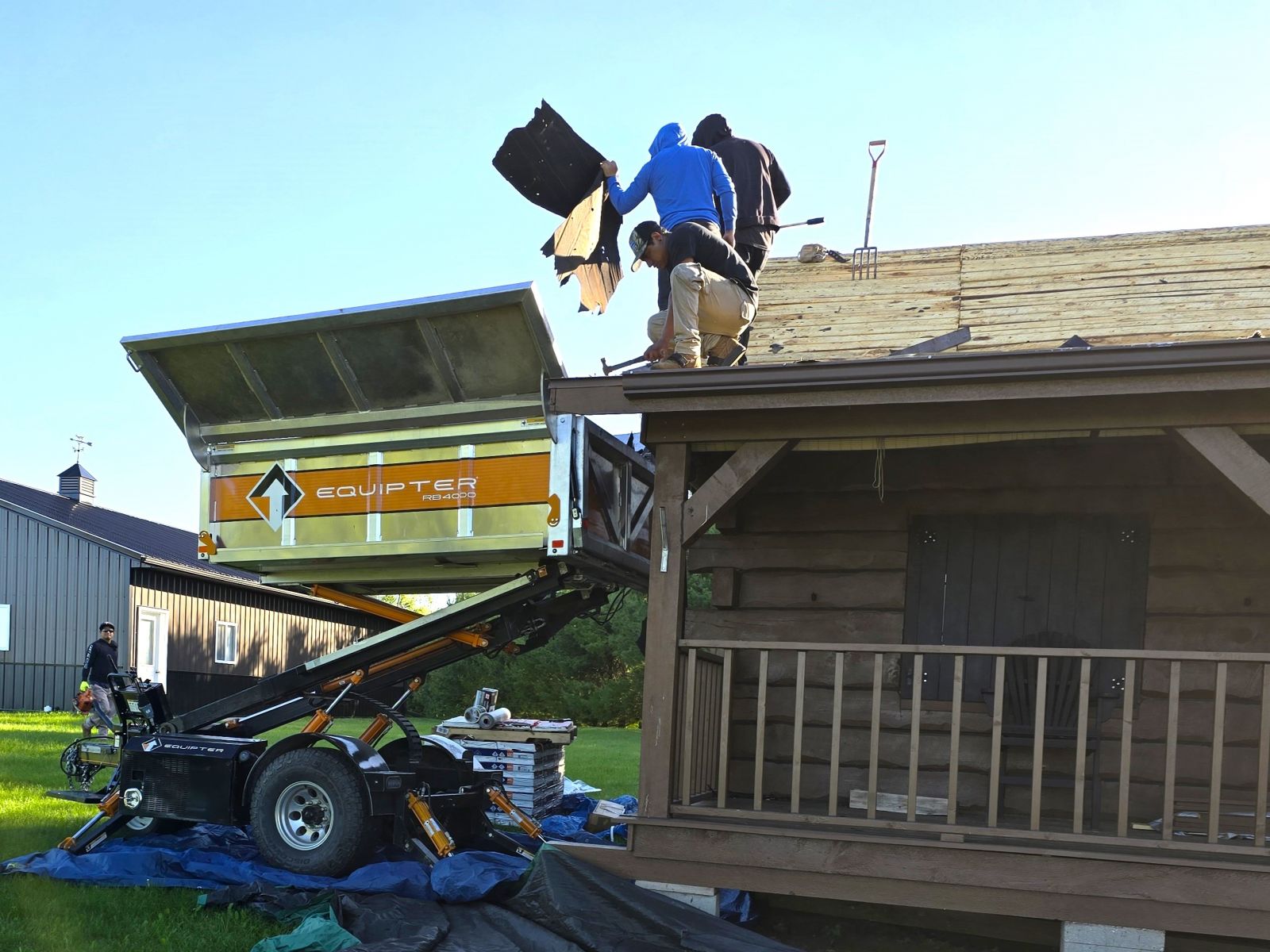 After image - New dark gray shingles installed on the roof of the same dark green home